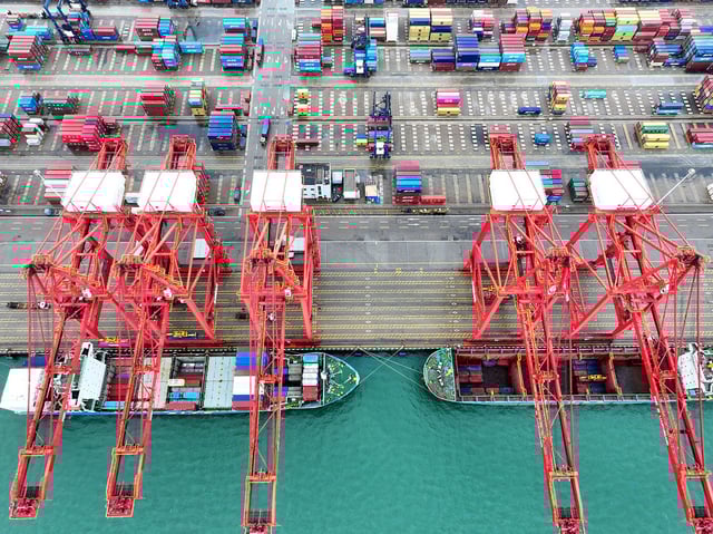 A cargo ship moors at the container terminal berth of Lianyungang Port for loading and unloading containers in Lianyungang City, Jiangsu Province, China, on May 9, 2025.