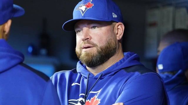 Apr 16, 2025; Toronto, Ontario, CAN; Toronto Blue Jays manager John Schneider talks with one of his assistant coaches before the start of the game against the Atlanta Braves at Rogers Centre. Mandatory Credit: John E. Sokolowski-Imagn Images