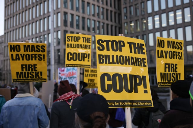 Demonstrators gather outside of the Office of Personnel Management in Washington, D.C. on February 7, 2025 to protest federal layoffs and demand the termination of Elon Musk from the Department of Government Efficiency (DOGE). A federal judge on May 9. 2025 called for a two-week pause in the Trump administration’s mass layoff plans.