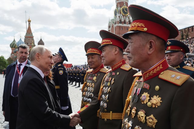 Russia&#39;s President Vladimir Putin meets with North Korean servicemen on Red Square after the Victory Day military parade in central Moscow on May 9, 2025.