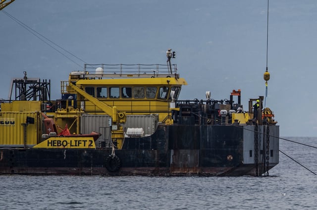 The multi-purpose floating work barge Hebo Lift 2 monitors the stretch of sea off Porticello, near Palermo, Sicily, Italy, Sunday, May 4, 2025, where the British superyacht Bayesian sunk on August 19, 2024 as the operations for its recovery start. (AP Photo/Salvatore Cavalli)