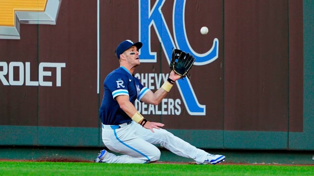 Royals outfielder Mark Canha makes a sliding catch during the third inning of a Friday, May 9, 2025 Major League Baseball game against the Boston Red Sox at Kauffman Stadium in Kansas City.