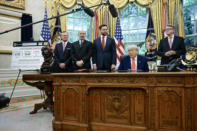 US President Donald Trump makes a trade announcement as US Secretary of Commerce Howard Lutnick (2L), US Vice President JD Vance (3L), and British ambassador to the United States Peter Mandelson (3R), look on in the Oval Office of the White House in Washington, DC, on May 8, 2025. A recent poll shows a drop in approval rating for the president when it comes to the economy.