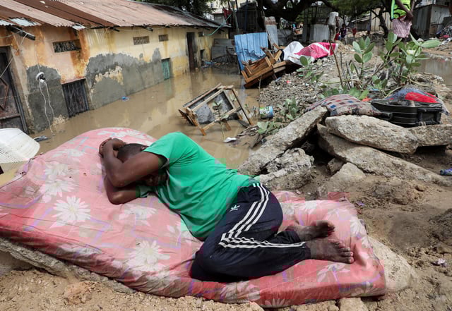 A Somali man rest on a mattress, after overnight rains caused damage to houses and infrastructure,  in Wadajir district of Mogadishu, Somalia May 10, 2025. REUTERS/Feisal Omar