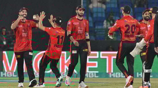 Lahore Qalandars' New Zealand all rounder Daryl Mitchell (L) with teammates