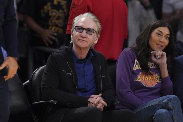 Comedian Bill Maher watches during the first half of an NBA basketball game between the Los Angeles Lakers and the Golden State Warriors, Thursday, April 3, 2025, in Los Angeles.