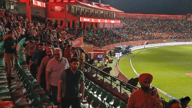 Spectators leave the HPCA stadium in Dharamsala following a blackout at the venue.