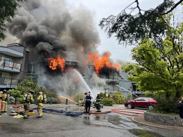 Flames shooting from a fire at a seniors' apartment complex in North Vancouver on Saturday, May 10, 2025.