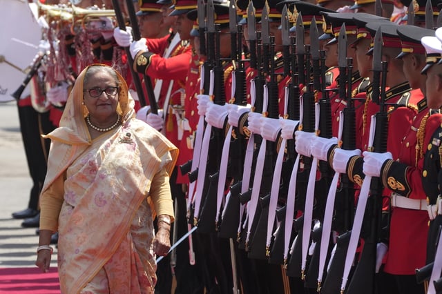 FILE - Bangladesh's Prime Minister Sheikh Hasina reviews an honor guard during a welcome ceremony at the government house in Bangkok, Thailand, Friday, April 26, 2024. (AP Photo/Sakchai Lalit, File)