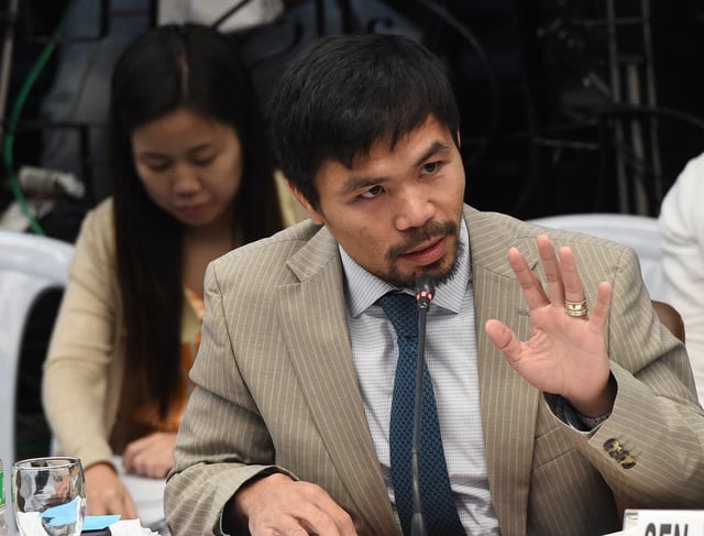 Boxer and senator Manny Pacquiao is running for President in the Philippines next year. In this photo, Pacquiao gestures as he asks questions to one of the invited witnesses (not pictured) during the second day of a senate hearing in Manila on August 23, 2016.