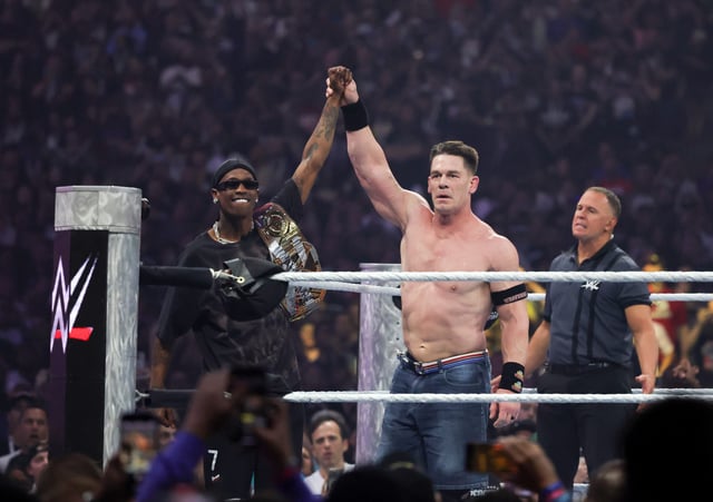 Rapper Travis Scott (L) is greeted by John Cena during his Undisputed WWE Championship match against Cody Rhodes during WrestleMania 41 at Allegiant Stadium on April 20, 2025 in Las Vegas, Nevada.