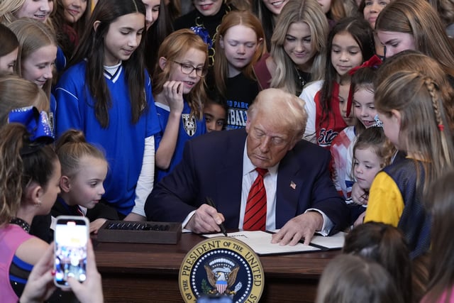 President Donald Trump signs an executive order barring transgender female athletes from competing in women&#39;s or girls&#39; sporting events, in the East Room of the White House, Wednesday, Feb. 5, 2025, in Washington.