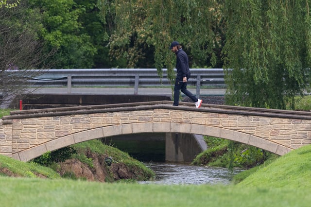 May 9, 2025; Philadelphia, Pennsylvania, USA; Tony Finau walks across a bridge on the 11th hole during the second round of the Truist Championship golf tournament. Mandatory Credit: Bill Streicher-Imagn Images/File Photo