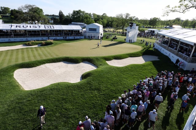May 10, 2025; Philadelphia, Pennsylvania, USA; General view of the 18th hole as Rory McIlroy and Collin Morikawa prepare to putt during the third round of the Truist Championship golf tournament. Mandatory Credit: Bill Streicher-Imagn Images