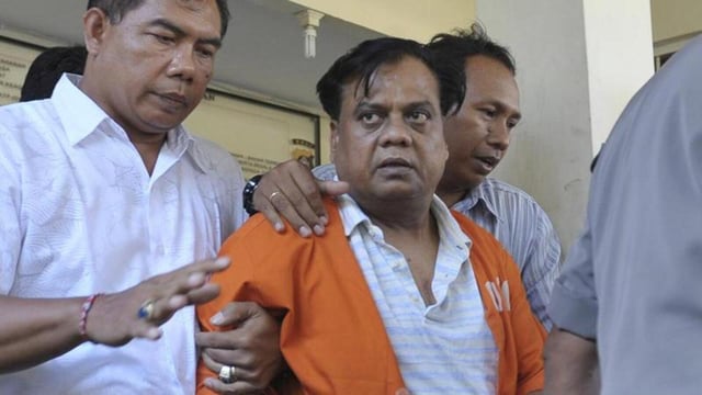 Police escort Indian gangster Rajendra Nikalje, widely known as Chhota Rajan, at police headquarters in Denpasar, Bali November 2, 2015 in this photo taken by Antara Foto. Indonesia will deport one of India's most wanted men on Tuesday to face charges in more than two dozen murder cases at home. Rajendra Nikalje was arrested by police on Indonesia's resort island of Bali last week, ending a two-decade-long international manhunt. Rajan has been on Interpol's wanted list since 1995 suspected of running a crime syndicate that engaged in extortion, arms struggling and contract killing. Picture taken November 2, 2015. REUTERS/Nyoman Budhiana/Antara Foto ATTENTION EDITORS - THIS IMAGE HAS BEEN SUPPLIED BY A THIRD PARTY. IT IS DISTRIBUTED, EXACTLY AS RECEIVED BY REUTERS, AS A SERVICE TO CLIENTS. FOR EDITORIAL USE ONLY. NOT FOR SALE FOR MARKETING OR ADVERTISING CAMPAIGNS. MANDATORY CREDIT. INDONESIA OUT. NO COMMERCIAL OR EDITORIAL SALES IN INDONESIA. TPX IMAGES OF THE DAY (REUTERS)