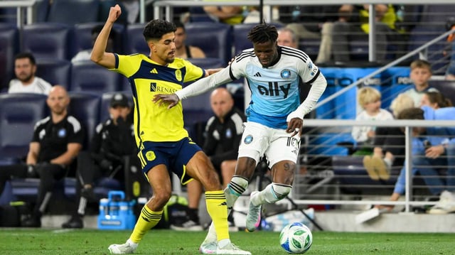 May 10, 2025; Nashville, Tennessee, USA; Nashville SC midfielder Patrick Yazbek (8) and Charlotte FC forward Wilfried Zaha (10) fights for the ball during the second period at Geodis Park. Mandatory Credit: Steve Roberts-Imagn Images
