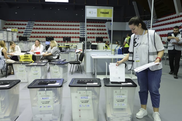 An employee handles the mail-in ballots , as Albania is heading to the polls on Sunday with Socialist Prime Minister Edi Rama seeks a fourth term, in Tirana, Albania, Friday, May 9, 2025. (AP Photo/Vlasov Sulaj)