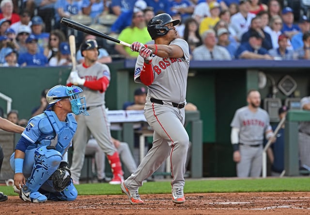May 10, 2025; Kansas City, Missouri, USA;  Boston Red Sox designated hitter Rafael Devers (11) hits an RBI double in the third inning against the Kansas City Royals at Kauffman Stadium. Peter Aiken-Imagn Images