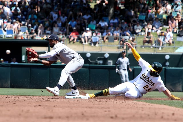 May 10, 2025; West Sacramento, California, USA; Athletics designated hitter Shea Langeliers (23) slides safely into second base against the New York Yankees during the third inning at Sutter Health Park. Dennis Lee-Imagn Images