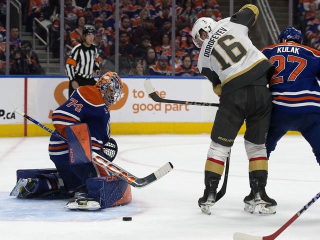 The Edmonton Oilers' goalie Stuart Skinner (74) makes a pad save as Brett Kulak (27) battles the Vegas Golden Knights' Pavel Dorofeyev (16) during second period NHL playoff action at Rogers Place, in Edmonton Saturday May 10, 2025. Photo by David Bloom