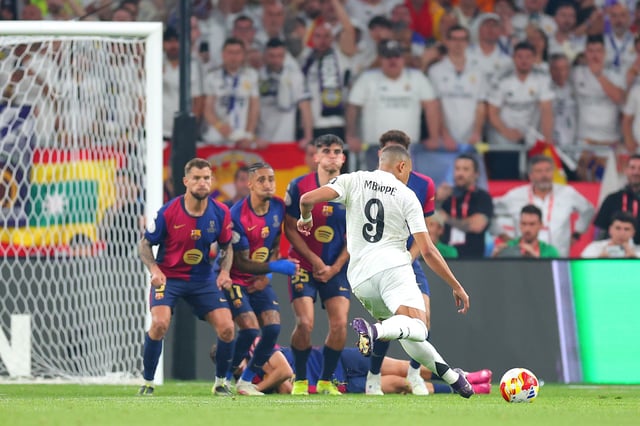 Kylian Mbappe of Real Madrid scores his team&#39;s first goal from a free kick during the Copa del Rey Final match between FC Barcelona and Real Madrid at Estadio de La Cartuja on April 26, 2025 in Seville, Spain.