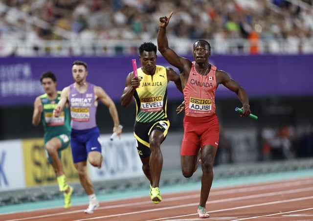 Athletics - World Athletics Relays 2025 - Guangdong Olympic Stadium, Guangzhou, China - May 11, 2025 Canada's Eliezer Adjibi celebrates after winning the mixed 4x100 metres relay final REUTERS/Tingshu Wang
