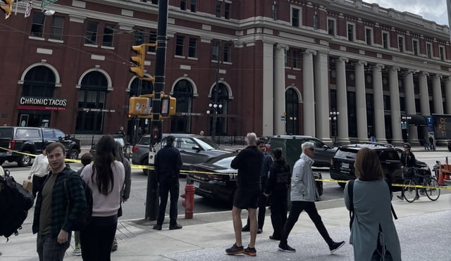 Police tape and police vehicles seen outside Vancouver's Waterfront Station on Sunday, May 11, 2025. 