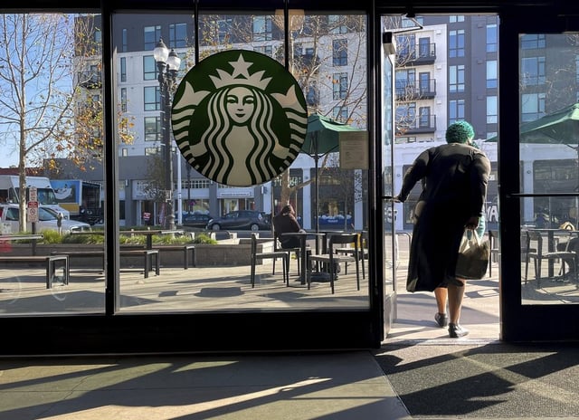 FILE - A customer exits a Starbucks store in Oakland, Calif., Jan. 16, 2025. 