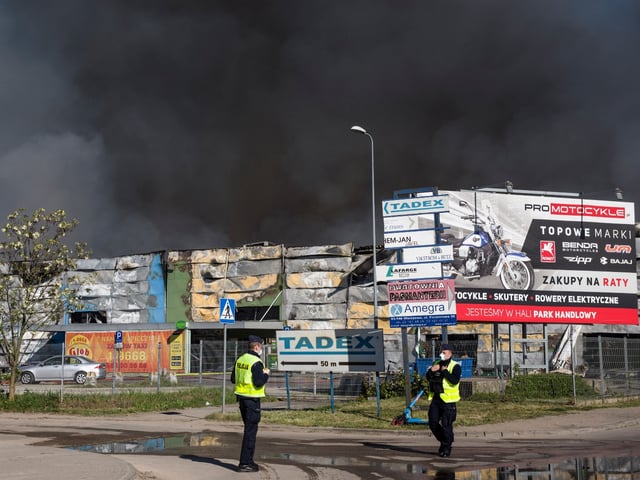 WARSAW, MASOVIAN VOIVODESHIP, POLAND - 2024/05/12: Black smoke seen in the sky above the burning Marywilska 44 shopping center in Warsaw. A massive fire broke out at the Marywilska 44 shopping center in Warsaw's Biaoleka district. According to the State Fire Service, there are 50 fire brigades on site, with a total of nearly 300 firefighters working there, including from the chemical unit. Water is drawn from a nearby canal to extinguish the fire. About 1400 shops are completely burnt down so far. Residents of Warsaw and the surrounding area received a government security center alert, urging them to stay at home and close their windows. (Photo by Attila Husejnow/SOPA Images/LightRocket via Getty Images)