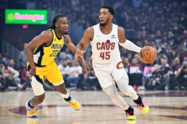 Aaron Nesmith #23 of the Indiana Pacers guards Donovan Mitchell #45 of the Cleveland Cavaliers during the first quarter of game one of the Eastern Conference Semifinals at Rocket Arena on May 04, 2025 in Cleveland, Ohio.