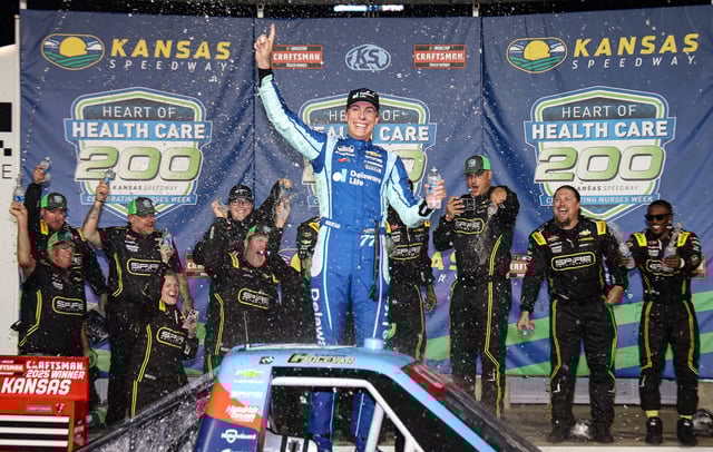 Carson Hocevar, driver of the #7 Delaware Life Chevrolet, celebrates in victory lane after winning the NASCAR Craftsman Truck Series Heart of Health Care 200 at Kansas Speedway on May 10, 2025 in Kansas City, Kansas.