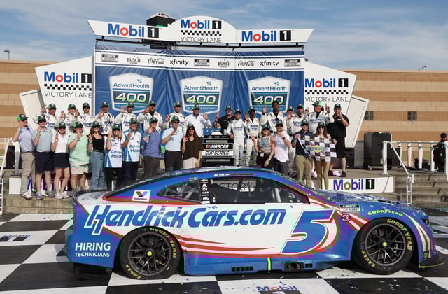 May 11, 2025; Kansas City, Kansas, USA; The team of NASCAR Cup Series driver Kyle Larson (5) pose for a photo in victory lane after winning  the AdventHealth 400 at Kansas Speedway. Mandatory Credit: Scott Sewell-Imagn Images