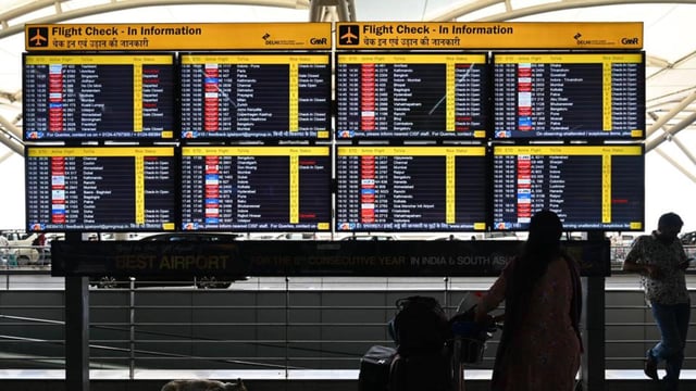 A passenger checks flight status at T3 of IGI Airport. (Vipin Kumar/HT Photo)