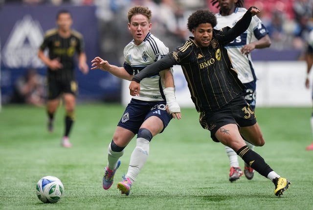 Vancouver Whitecaps' Tate Johnson, left, and Los Angeles FC's David Martinez vie for the ball during the first half of an MLS soccer match, in Vancouver, on Sunday, May 11, 2025. THE CANADIAN PRESS/Darryl Dyck