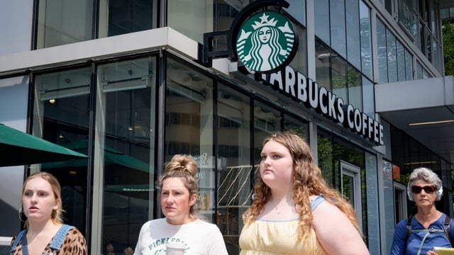 Patrons leave a Starbucks location in Toronto. The United Steelworkers union says workers at five Starbucks locations in Ontario have ratified their first collective agreements.
