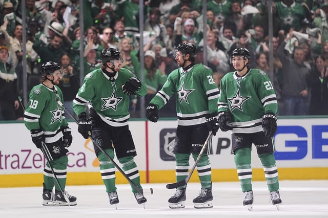 Dallas Stars' Sam Steel (18), Lian Bichsel (6), Alexander Petrovic (28) and Jason Robertson (21) celebrate after Petrovic scored in the third period of Game 3 of a second-round NHL hockey playoff series against the Winnipeg Jets in Dallas, Sunday, May 11, 2025. (AP Photo/Julio Cortez)