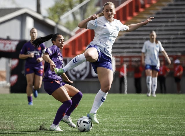 Ottawa Rapid's Ellen Gibson, right, battles for the ball with Calgary Wild's Jaclyn Sawicki during first half Northern Super League soccer action in the in Calgary, on Sunday, May 11, 2025. THE CANADIAN PRESS/Jeff McIntosh
