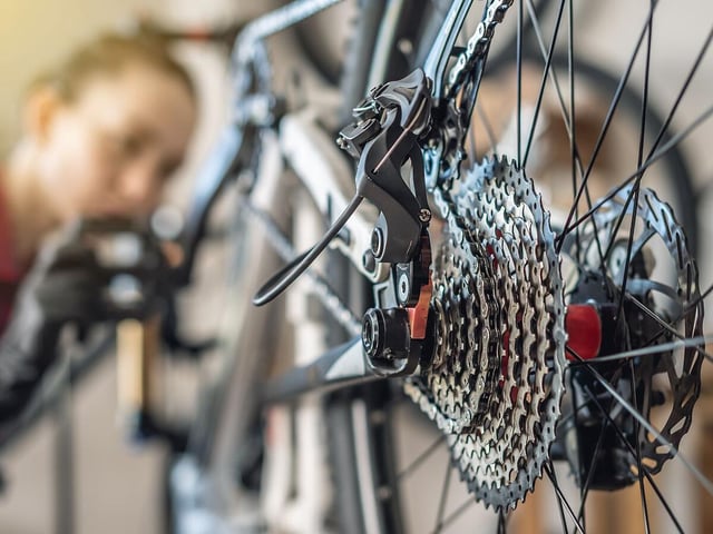 Woman is performing maintenance on mountain bike. Concept of fixing and preparing the bicycle for the new season