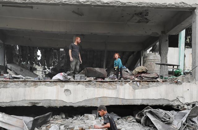 Palestinians inspect the damage at a school sheltering displaced people, following an Israeli strike, in Jabalia refugee camp, in the northern Gaza Strip, May 12, 2025. REUTERS/Mahmoud Issa