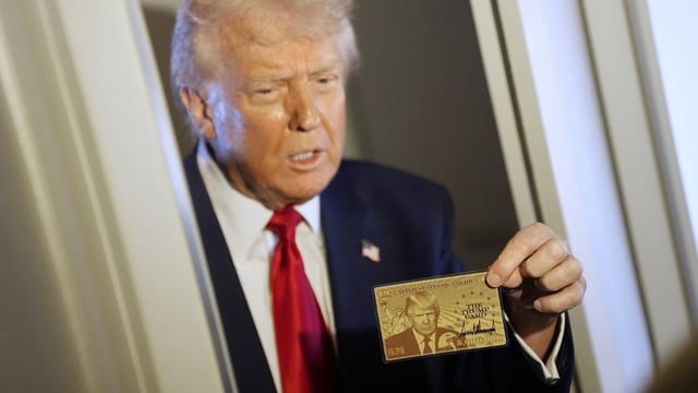 President Donald Trump holds up the gold card on April 3, 2025. The card offers citizenship to immigrants in exchange for a whopping premium of $5 million.