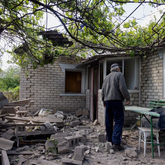 A local resident looks at a damaged private house after Russian shelling in Kramatorsk, Donetsk region on May 11, 2025, amid the Russian invasion of Ukraine. (Photo by Tetiana DZHAFAROVA / AFP) (Photo by TETIANA DZHAFAROVA/AFP via Getty Images)