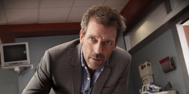 Hugh Laurie as Doctor House looking at a person or object offscreen in House