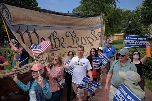 WASHINGTON, DC - MAY 01: Demonstrators march in Lafayette Square near the White House to demand the return of Kilmar Armando Abrego Garcia to the United States and to mark the May Day holiday on May 01, 2025 in Washington, DC.