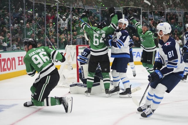 Dallas Stars' Mikko Rantanen (96), Mikael Granlund (64) and Roope Hintz, rear, celebrate Rantanen's goal as Winnipeg Jets' Neal Pionk (4) and Kyle Connor (81) look on in the third period of Game 3 of a second-round NHL hockey playoff series in Dallas, Sunday, May 11, 2025. (AP Photo/Julio Cortez)