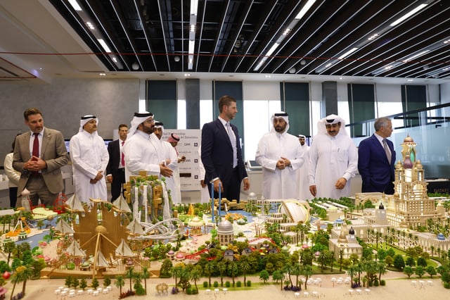 Eric Trump, executive vice president of the Trump Organization and the US president&#39;s son, looks over the proposed plan ahead of the signing ceremony with Qatar&#39;s Diar and Dar Global in Doha on April 30, 2025.