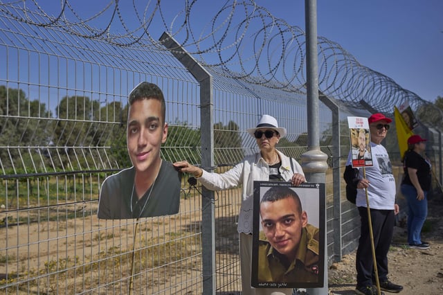 FILE - Varda Ben Baruch, holds a picture of her grandson Edan Alexander who is held hostage in Gaza, near the Gaza border in Kibbutz Nir Oz, southern Israel, on April 20, 2025. (AP Photo/Ohad Zwigenberg, File)