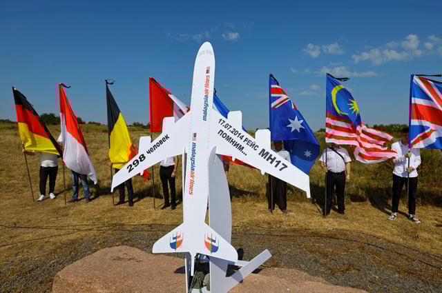 People hold flags at a memorial to victims of the Malaysia Airlines Flight MH17 plane crash during a ceremony marking the 10th anniversary of the accident, near the village of Hrabove (Grabovo) in the Donetsk region, Russian-controlled Ukraine, July 17, 2024. REUTERS/Alexander Ermochenko/File Photo