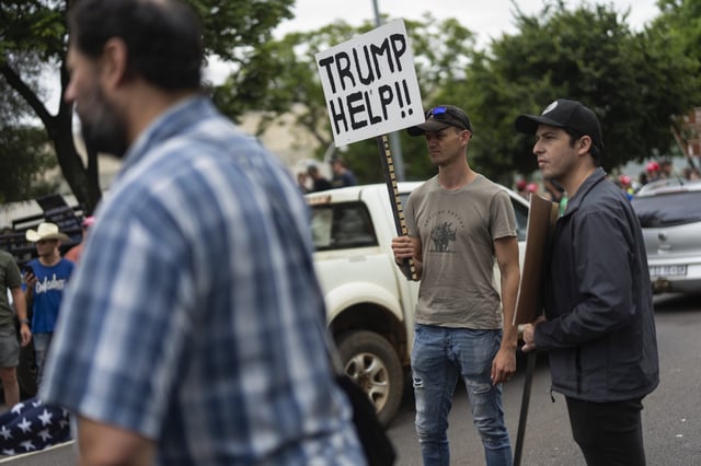 White South Africans demonstrate in support of U.S. President Donald Trump in front of the U.S. embassy in Pretoria, South Africa, Saturday, Feb. 15, 2025.