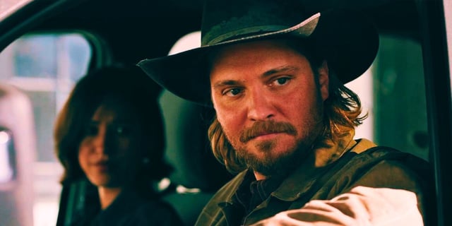 Kayce (Luke Grimes) and Monica Dutton (Kelsey Asbille) sitting in a truck on 'Yellowstone'
