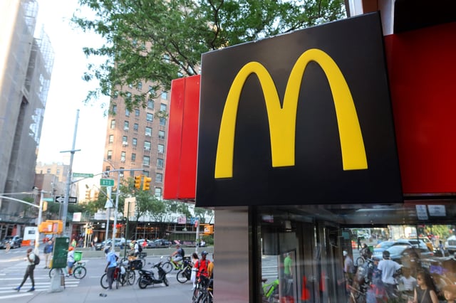 A McDonald&#39;s corporate logo hangs above the entrance of their restaurant on Amsterdam Avenue on June 25, 2024, in New York City.